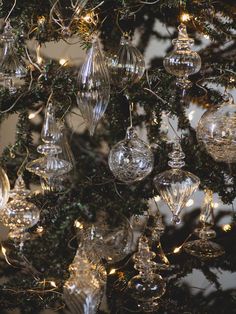 a christmas tree with ornaments hanging from it's branches