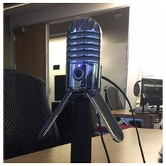 a microphone sitting on top of a wooden table