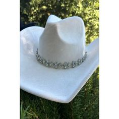 Vegan suede cowboy hat with chain of rhinestones arranged in a floral pattern. Great for concerts, parties, and bridal events. Structured brim. Crown size: 57 cm. Adjustable inner drawstring. 100% polyester Country Style Rhinestone Hats For Rodeo, Western Style Adjustable Hat With Rhinestone Fringe, Adjustable Western Jewelry For Party, Adjustable Western Style Party Jewelry, Adjustable Western Style Jewelry For Parties, Silver Hat With Rhinestones For Rodeo, Silver Rhinestone Hat For Rodeo, White Adjustable Hat With Rhinestones, Adjustable Country Style Hat Bands For Party