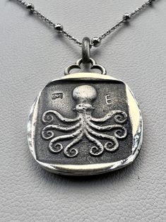 "REPRO ANCIENT GREEK COIN OCTOPUS ERETRIA  counts among the first cities in Greece proper to strike their own silver coins. The analysis of several hoards has shown that the earliest coins struck in Eretria were contemporary with the first \"owls\" in Athens. This Eretria coinage is dated ca. 520-510 BC, at the time of the fall of the Pisistratus and the end of the Athenian \"Wappenmünzen\" (heraldic coins).On their obverse, Eretria's coins bear an image of a standing cow, the head turned back, Symbolic Silver Coin Necklace, Silver Symbolic Coin Necklaces, Silver Coin Necklaces With Symbolic Style, Symbolic Handmade Coin Necklaces, Sterling Silver Oxidized Medallion Coin Necklace, Silver Engraved Symbolic Coin Necklace, Sterling Silver Medallion Coin Necklace With Oxidized Finish, Handmade Sterling Silver Coin Necklace, Handmade Sterling Silver Coin Pendant Necklace