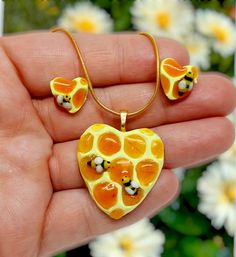 Beautiful and unique  honeycomb jewelry made in the shape of a heart with miniature bees! A great piece for summer wear and lover's of the honey bee. Takes a couple of days to make and then they're shipped out. Handmade with clay and resin to be a whole set or individual pieces of jewelry. The gold necklace chain is stainless steel and 20in long. The gold stud backings are stainless steel as well. The ring is gold alloy and is adjustable. The ring will also have a choice if you want the big heart or the little heart. Set includes: Ring,studs and necklace! Thankyou and happy summer days! Handmade Honey Color Jewelry Gift, Handmade Honey Jewelry For Gift, Handmade Honey-colored Jewelry For Gifts, Handmade Heart-shaped Amber Jewelry, Yellow Resin Jewelry With Matching Earrings, Yellow Resin Jewelry Gift, Handmade Amber Heart Jewelry, Yellow Resin Jewelry As Gift, Yellow Resin Jewelry For Gifts