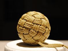 a rope ball sitting on top of a white container