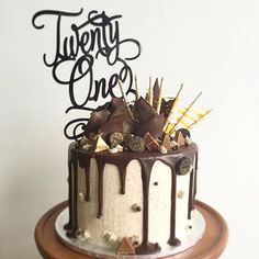 there is a cake with chocolate icing and decorations on the top that says twenty one