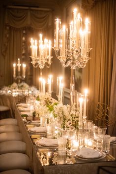 a long table is set with candles and flowers for a formal dinner or party event