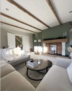 a living room filled with furniture and a fire place in the middle of the room