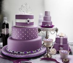 a table topped with purple and white cakes