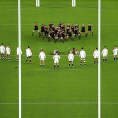 several soccer players are standing on the field and facing each other in opposite directions,