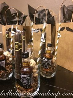 bottles filled with different types of liquor sitting on top of a table next to paper bags