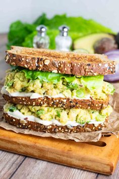 a sandwich with avocado, cucumber and lettuce on it