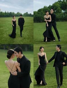 two people dressed in black are posing for pictures on the grass, one is holding the other's hand