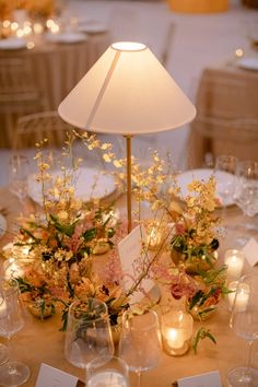 the table is set with candles and flowers