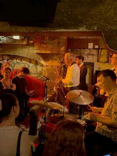 a group of people playing instruments in front of a crowd