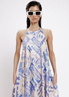 A bias halter dress with an adjustable tie-up detail at the back of the neck. This maxi dress showcases an asymmetrical hem, providing an airy and twirly feel, and features convenient side pockets. The print is inspired by local tailoring shops in Mumbai, paying tribute to the workforce behind the garment industry, and is dyed using azo-free chemicals. Crafted from soft and luxurious bemberg twill satin, the fabric exhibits a splendid sheen. Halter Slip Dress, Shopping In Mumbai, Rahul Khanna, Garment Industry, Nehru Jackets, Western Wedding, Wedding Service, Short Suit, Bride Bridal