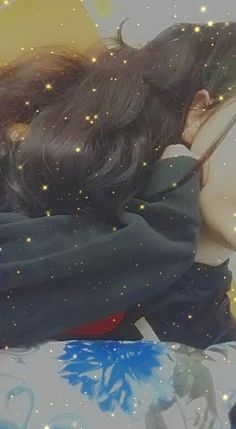 a woman laying on top of a bed covered in stars