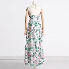 This absolutely breathtaking midi dress is the perfect dress for Spring & Summer. Gorgeous white strapless dress with sweetheart neckline and halter tie. Ruched top with flattering A-Line silhouette and all over green and pink floral print. Beautiful chiffon ruffles. Fully lined. Back zip. Perfect for Spring, Summer and weddings. Wash cold, gentle cycle. Women's sizes: S-XL. Fabric has slight stretch, runs true to size. Order your normal size. Good things take time. Quicker shipping: This dress ships directly to you from our overseas warehouse, and will arrive in approximately 7-12 business days. Limited Stock. Please note: this is a HIGH HEAT item. The manufacturer is working hard to ship out all orders ASAP, and this may need an extra few days to ship out. Strapless Green Sundress For Spring, Spring Backless Strapless Dress With Tie Back, Spring Strapless Backless Dress With Tie Back, Spring Tie-back Backless Strapless Dress, Green Floral Strapless Dress For Spring, Pink Midi Strapless Dress For Beach, Spring Green Halter Dress For Garden Party, Pink Halter Sundress For Brunch, Green Spring Halter Dress For Garden Party