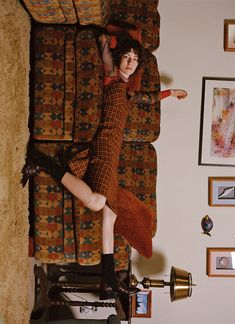 a woman laying on top of a couch in a living room