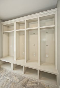 an empty white shelf in the corner of a room