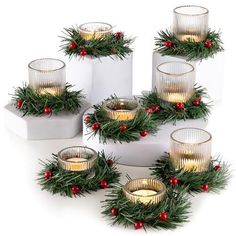 christmas candles are arranged in the shape of wreaths