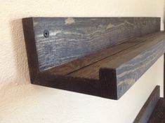 a wooden shelf mounted to the side of a wall