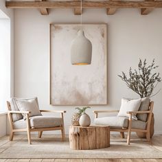 a living room with two chairs and a table in front of a painting on the wall