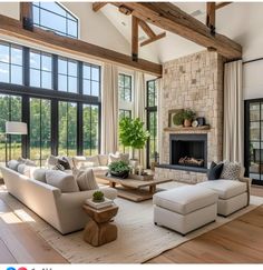 a living room filled with furniture and large windows