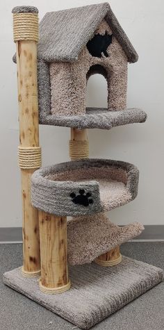 the cat tree is made out of wood and has three levels to climb up it