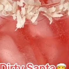 a close up of a drink in a glass with the words dirty santa on it