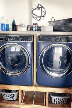 two washers stacked on top of each other in front of a dryer and drying rack