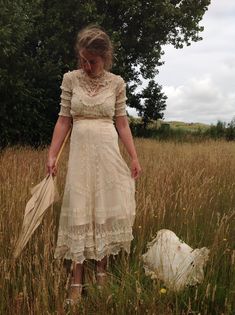 "A very beautiful tulle lace dress with a lovely tiny floral pattern, and lace ruffles it has a cream color This dress has a bit stretch and will a fit waist 70 cm 27.5\" bust 88 cm 34.5\" total length of the dress: 145 cm 57\" This dress has many discolorations and repairs. I saw several tiny holes, and there is brown underarm discoloration (picture 8) The dress is very beautiful because f the wonderful floral lace, the lace ruffles, the embroidery work and it's shape... My model is wearing a s Fitted Lace Dress With Ruffles For Garden Party, Victorian Lace Trim Dress For Garden Party, Cream Lace Dress With Ruffles, Cream Prairie Dress With Ruffles For Garden Party, Beige Vintage Dress With Ruffles For Garden Party, Beige Ruffled Vintage Dress For Garden Party, Spring Victorian Lace Dress For Garden Party, Victorian Style Fitted Vintage Dress In White, Cream Fitted Lace Dress For Garden Party