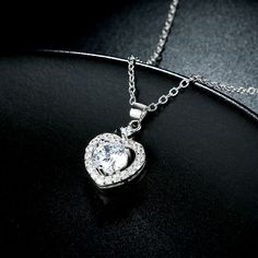 A sparkling tribute to you, this heart halo necklace is a special look you are certain to adore. Crafted in sterling silver, it features a open heart-shaped frame centered with a bright round cut stone. Smaller stones adorns heart frame, adding subtle sparkle. It's a sweet and romantic gift for you or your loved ones.Weight: 3.5 gWidth: 12 mmHeight: 20 mmMaterial: Plating Color: SilverLength: 400 mm White Gold Heart Necklace, Swarovski Heart, Pave Necklace, Swarovski Crystal Hearts, Cheap Necklaces, Halo Necklace, Wedding Pendant, Heart Shaped Necklace, Gold Heart Necklace