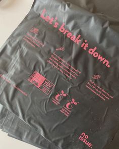 there is a black bag with pink writing on it that says let's break it down