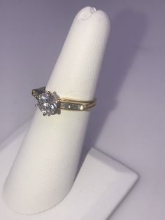 14k yellow gold Diamond Engagement Ring. Center Diamond is .98 ct. I1 clarity, I color, Baguettes total weight .15ct. Size 6 1/4, Circa 2000-2009 Timeless 14k Gold Diamond Ring Vs Clarity, Dazzling Diamond Ring With Baguette Cut Center Stone, Yellow Gold Jewelry With Princess Cut Brilliant Diamond, Elegant 14k Gold Wedding Ring With Vs Clarity, Yellow Gold Jewelry With Princess Brilliant Cut, Yellow Gold Jewelry With Brilliant Princess Cut, Classic Baguette Cut Diamond Ring With Vs Clarity, Yellow Gold Princess Cut Brilliant Jewelry, Anniversary Diamond Ring With Vs Clarity In Baguette Cut