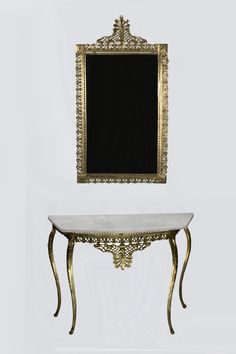 a table with a mirror on top of it next to a white wall and floor