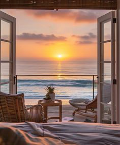 the sun is setting over the ocean as seen through an open door to a bedroom