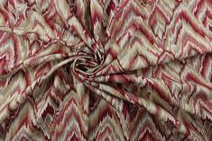 a red and beige fabric with an abstract design