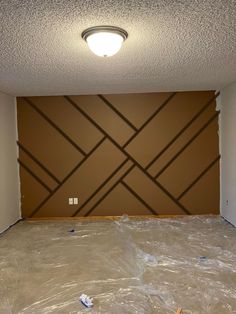 an empty room with plastic covering the floor and walls in place for paint on the wall