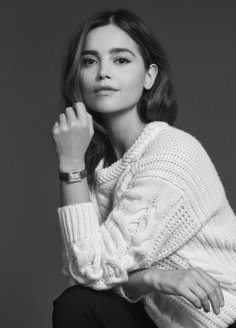 black and white photograph of a woman wearing a sweater with her hand on her chin