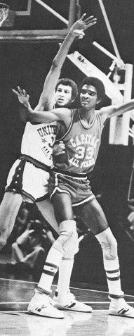 two men are playing basketball on a court