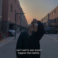 a man is standing on the street with a paper bag over his head