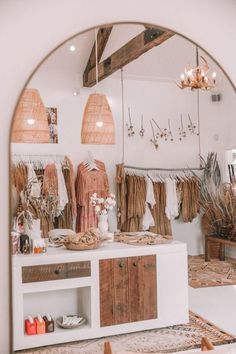 the inside of a clothing store with clothes on display