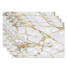 four white and gold marble placemats on a white background with gold foiling