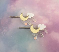 "Celestial moon & clouds hair clips! This listing is for 1 single clip. Gold mirrored crescent moon sits upon clear glitter and white clouds, with dangly iridescent raindrops. Acrylic with silver metal bobby pin. 1.25\" across x about 1.25\" tall (not including bobby pin). Choose which side of the head you want this to be worn on: left side or right side. If purchasing more than one piece, please leave your preferences in \"note to seller\" at checkout." Crescent Moon Hair Clip, Cloud Hair Accessories, Space Hair Clips, Cloud Hair Clip, Cloud Accessories, Emoji Base, Moon Hair Clip, Space Hair, Kawaii Hair Clips