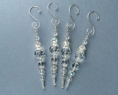 three pairs of dangling earrings with crystal beads on the end of each earwires