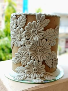 there is a cake that has been decorated with flowers on the top and bottom layer