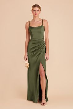 a woman wearing a green dress with a slit