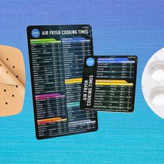 an air fryer cooking times card next to two rolls of doughnuts on a blue background