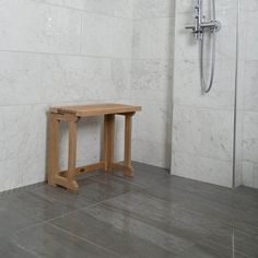 a wooden bench sitting in front of a shower