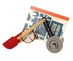 a wooden toy with an instrument on it's side and a book in the background