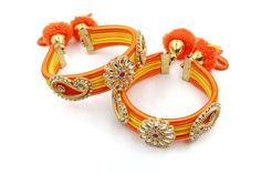 two orange and yellow bracelets with flowers on them