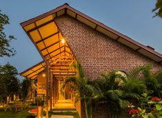 a house that is made out of bricks and has a walkway leading up to it